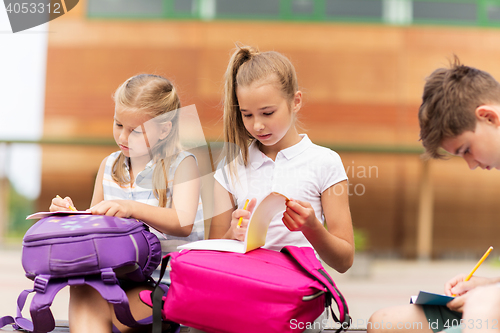 Image of group of happy elementary school students outdoors