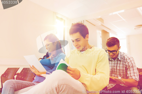 Image of group of smiling students in lecture hall