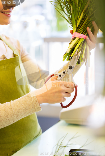 Image of close up of woman with flowers and scissors