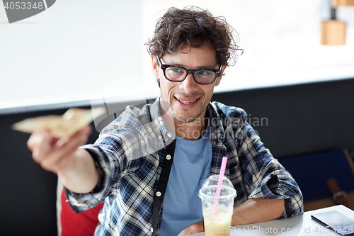 Image of happy man with cash money paying at cafe