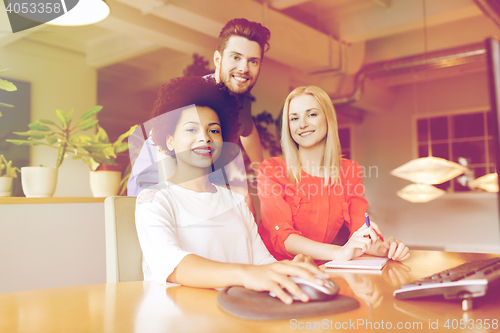 Image of happy creative team in office
