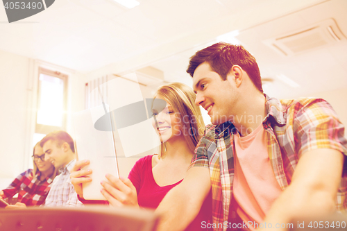 Image of group of smiling students with tablet pc
