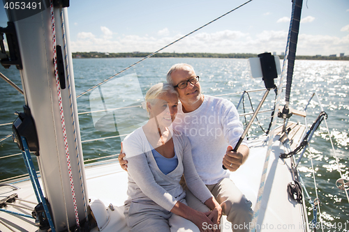 Image of senior couple taking selfie on sail boat or yacht