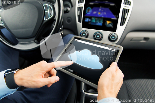 Image of close up of man with tablet pc in car