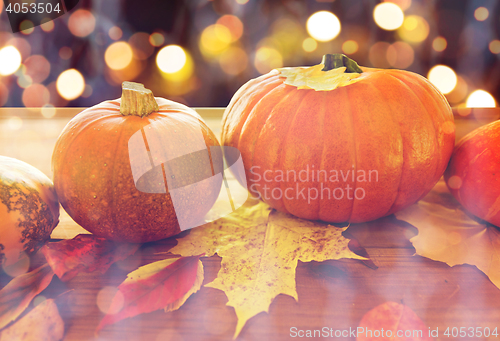 Image of close up of halloween pumpkins on wooden table