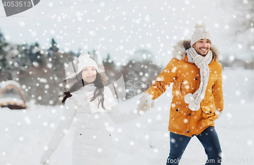 Image of happy couple walking over winter background