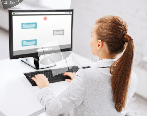 Image of businesswoman with messenger on computer at office