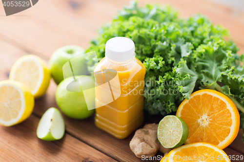 Image of bottle with orange juice, fruits and vegetables