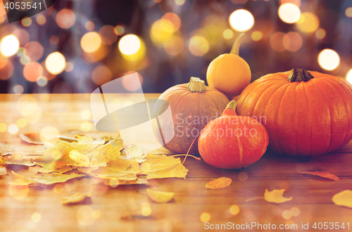 Image of close up of halloween pumpkins on wooden table