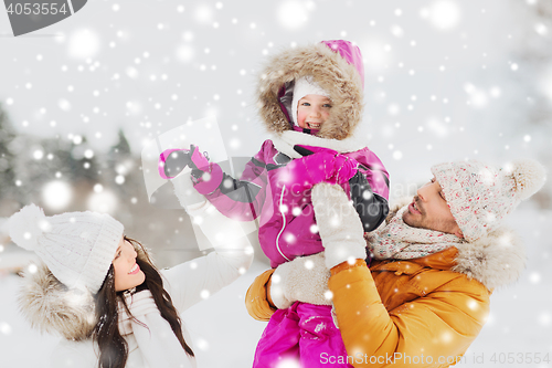 Image of happy family with child in winter clothes outdoors