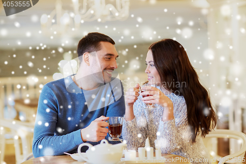 Image of happy couple drinking tea at cafe