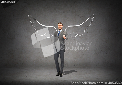 Image of businessman with angel wings showing thumbs up