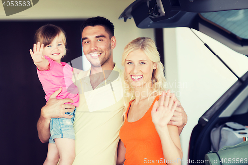 Image of happy family with hatchback car at home parking