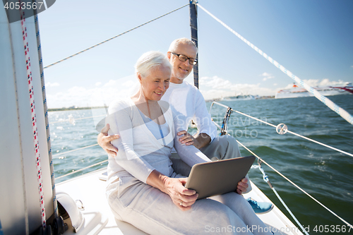 Image of senior couple with tablet pc on sail boat or yacht