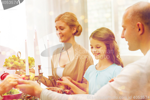 Image of smiling family having holiday dinner at home
