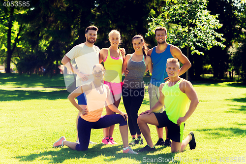 Image of group of happy friends or sportsmen outdoors