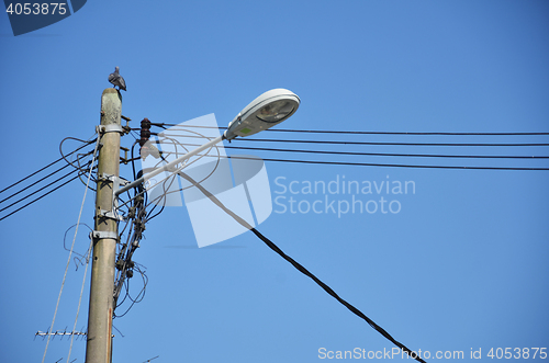 Image of Lamp post with many cables
