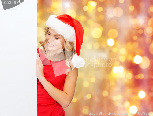 Image of woman in santa helper hat with blank white board