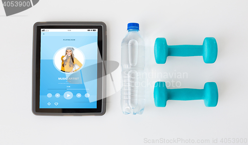 Image of close up of tablet pc, dumbbells and water bottle