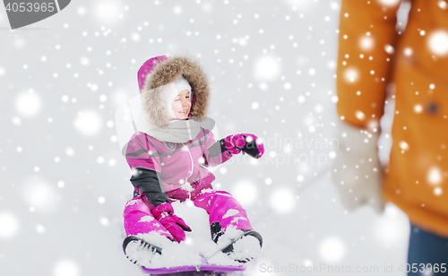 Image of happy little kid on sled outdoors in winter