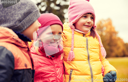 Image of group of happy children hugging in autumn park