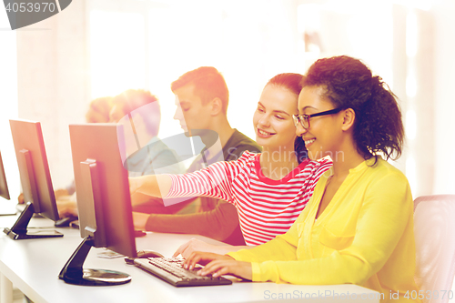 Image of smiling students in computer class at school