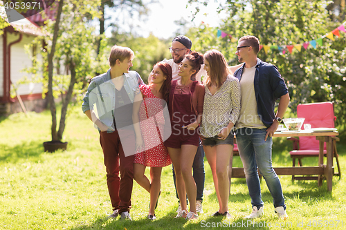 Image of happy teenage friends hugging at summer garden