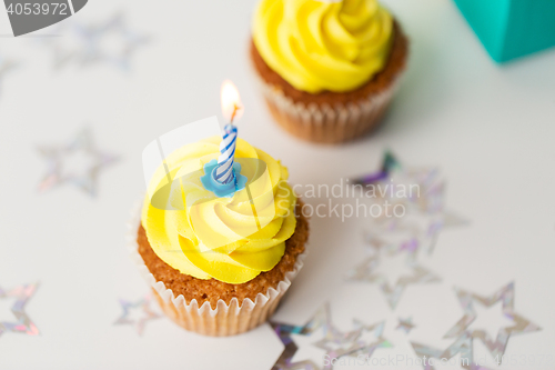 Image of birthday cupcakes with burning candles