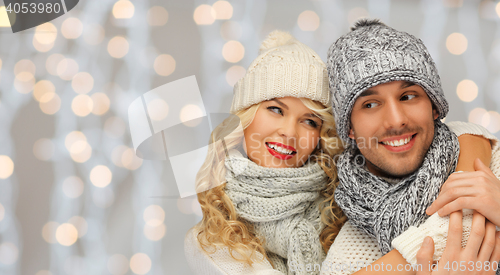 Image of happy family couple in winter clothes hugging