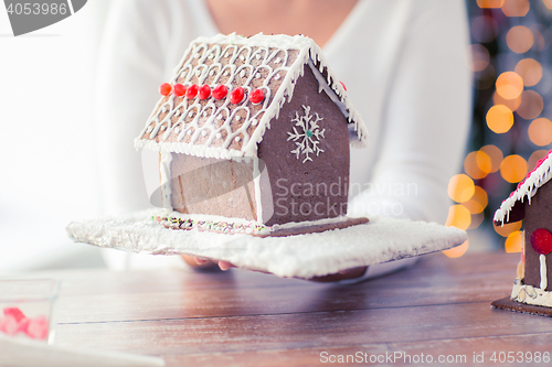 Image of close up of woman showing gingerbread house