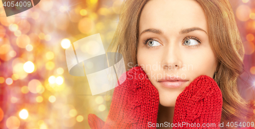 Image of close up of beautiful woman in red mittens