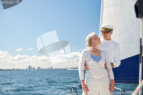 Image of senior couple hugging on sail boat or yacht in sea