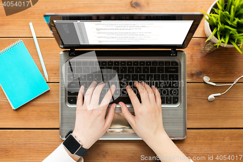 Image of close up of woman or student typing on laptop