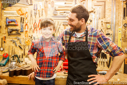 Image of happy father and little son workshop