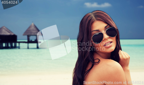 Image of young woman with sunglasses on beach