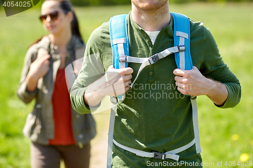 Image of close up of couple with backpacks hiking outdoors