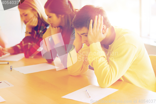 Image of group of students with papers