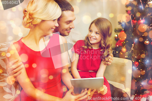 Image of smiling family with tablet pc