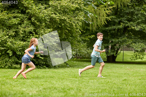 Image of happy kids running and playing game outdoors