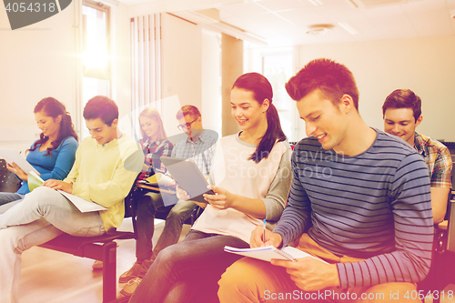 Image of group of smiling students with tablet pc