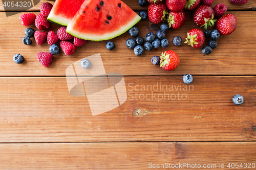 Image of close up of fruits and berries on wooden table