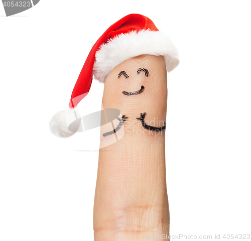 Image of close up of one finger in santa hat