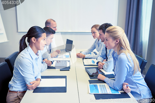 Image of smiling business people having conflict in office