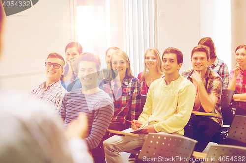 Image of group of students and teacher with notebook