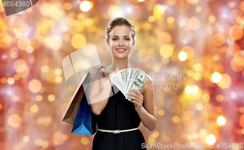 Image of smiling woman in dress with shopping bags