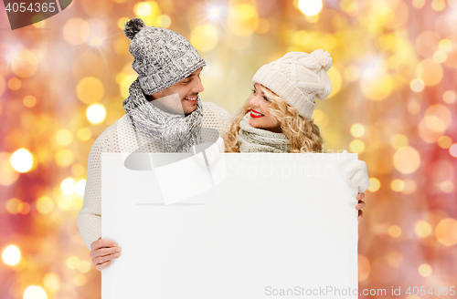 Image of couple in winter clothes with blank white board