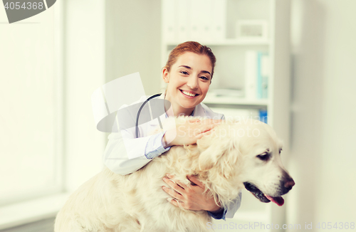 Image of happy doctor with retriever dog at vet clinic