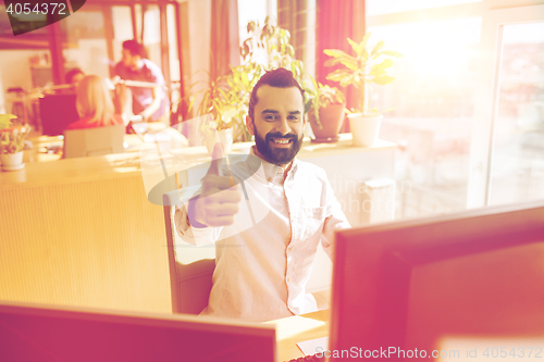 Image of happy male office worker showing thumbs up