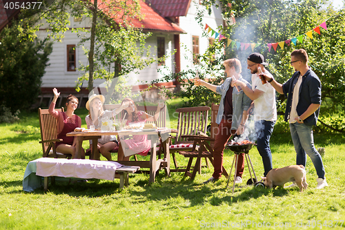 Image of friends drinking beer at summer barbecue party