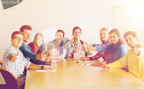 Image of group of smiling students with hand on top